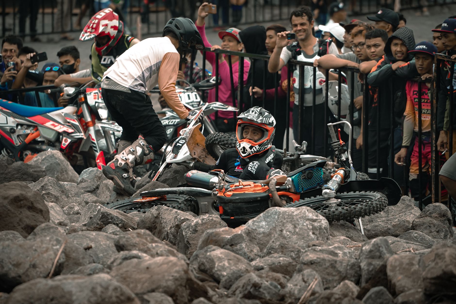 Motocross riders navigate rocky terrain in a thrilling race event in Yogyakarta.