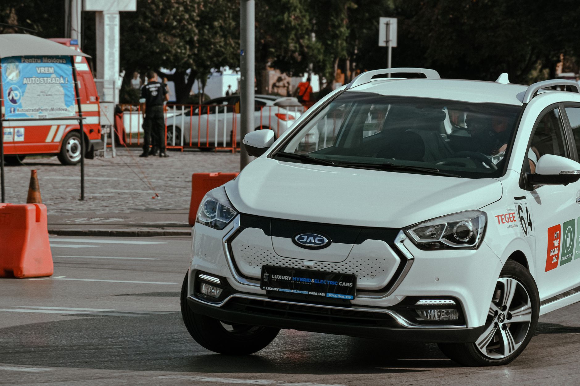 White modern car racing in city center and driving fast while turning on racetrack