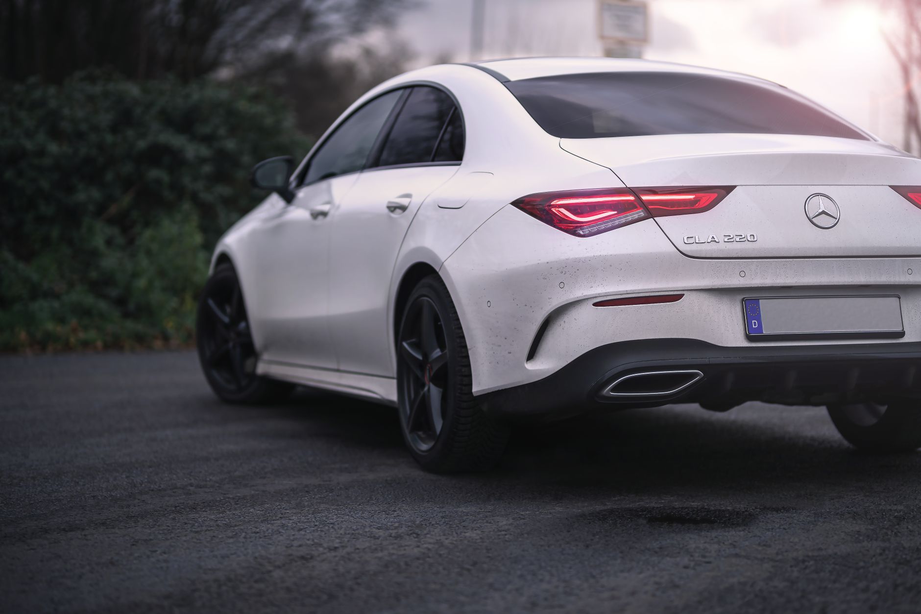 A sleek and modern white Mercedes Benz GLA 220 parked on an outdoor road. Ideal for automotive themes.