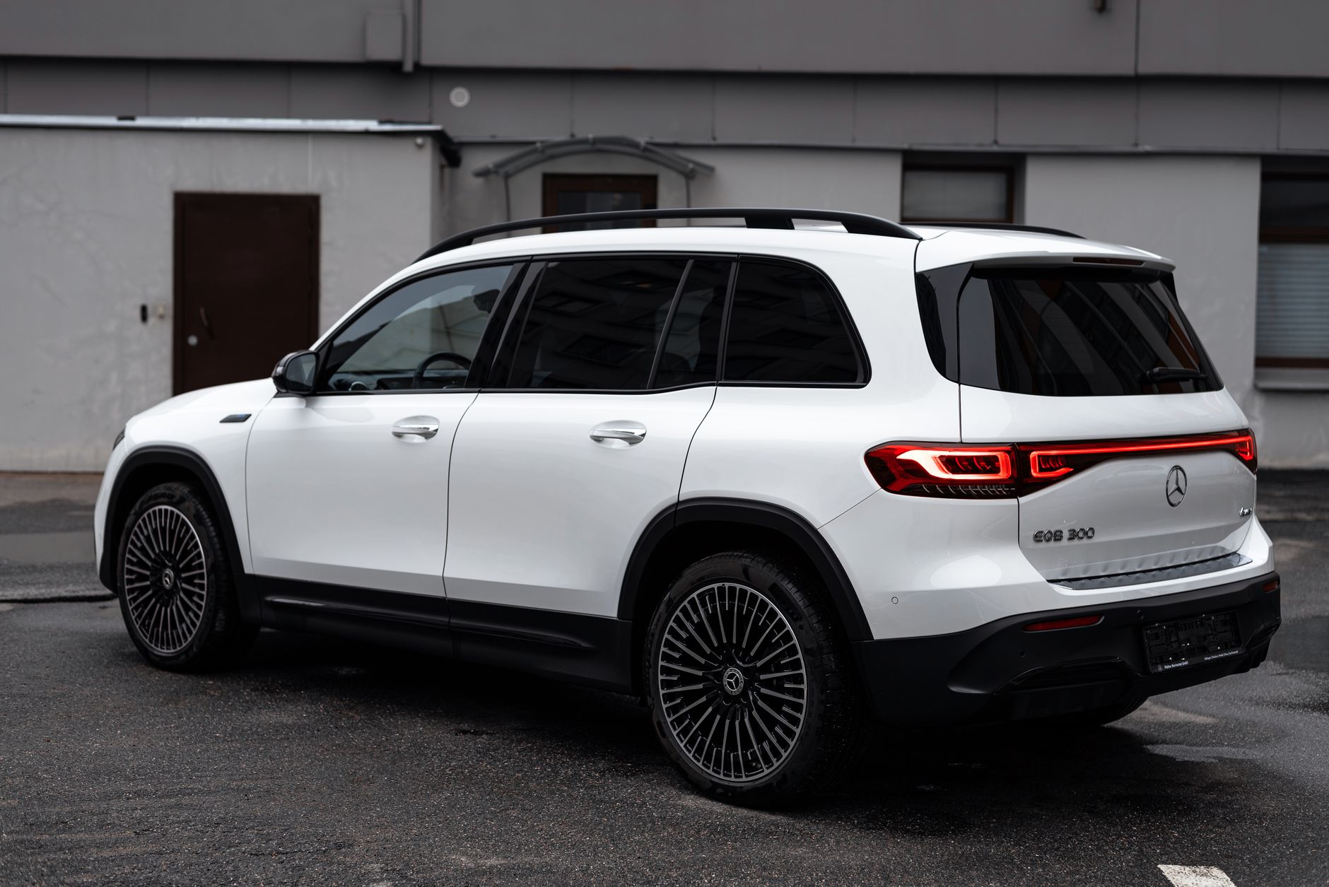 A luxury Mercedes-Benz EQB SUV parked outdoors in a modern city environment.