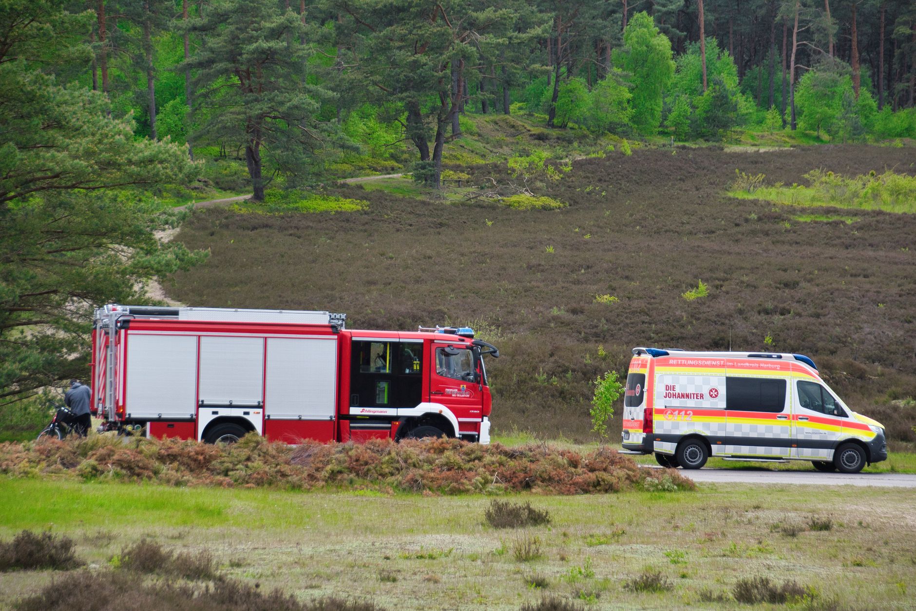 Firetruck and ambulance in a forest scene in Germany, providing emergency rescue services.