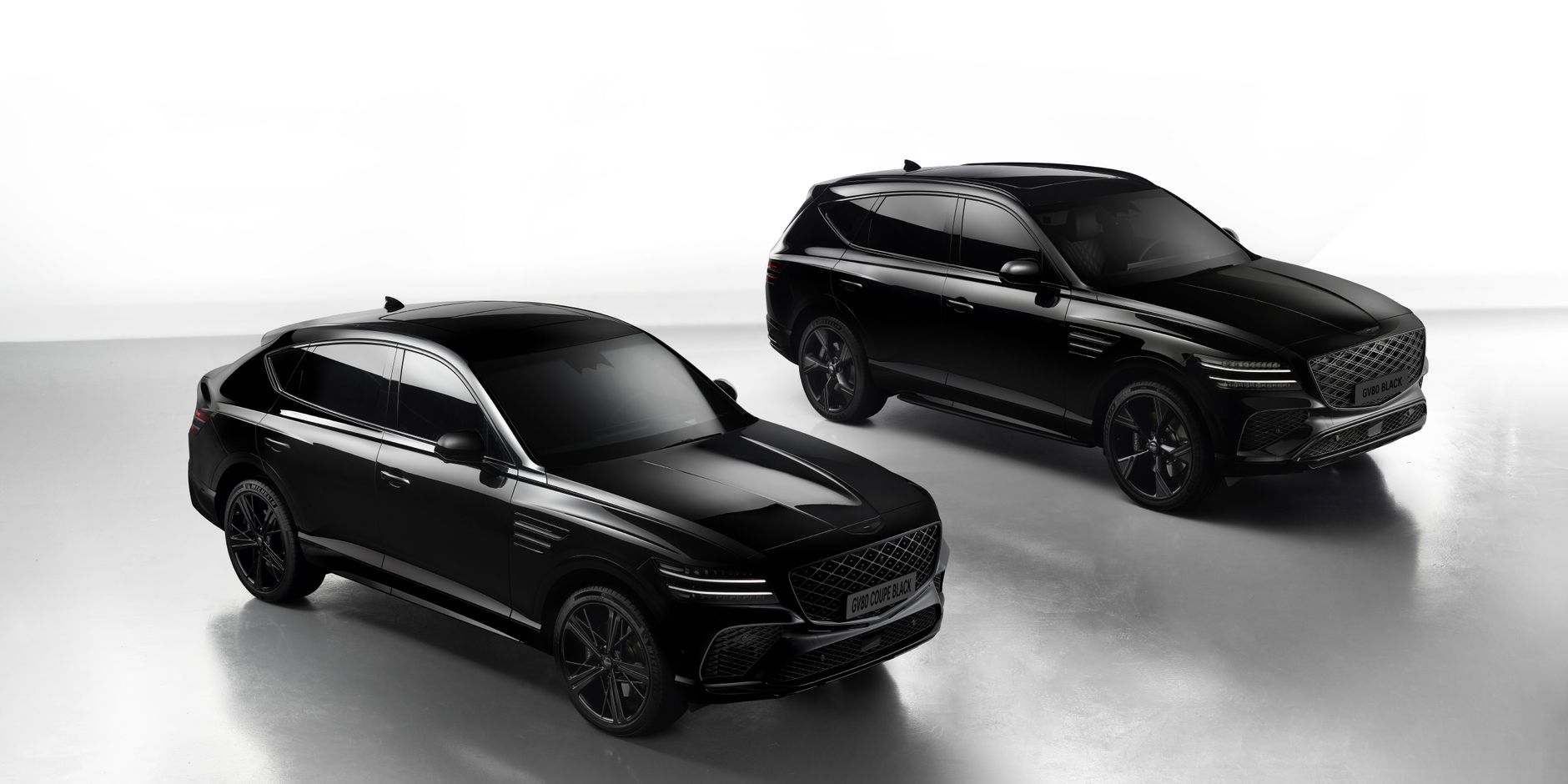 Sleek black Genesis GV80 SUVs showcased in a professional studio setting, emphasizing luxury and design.