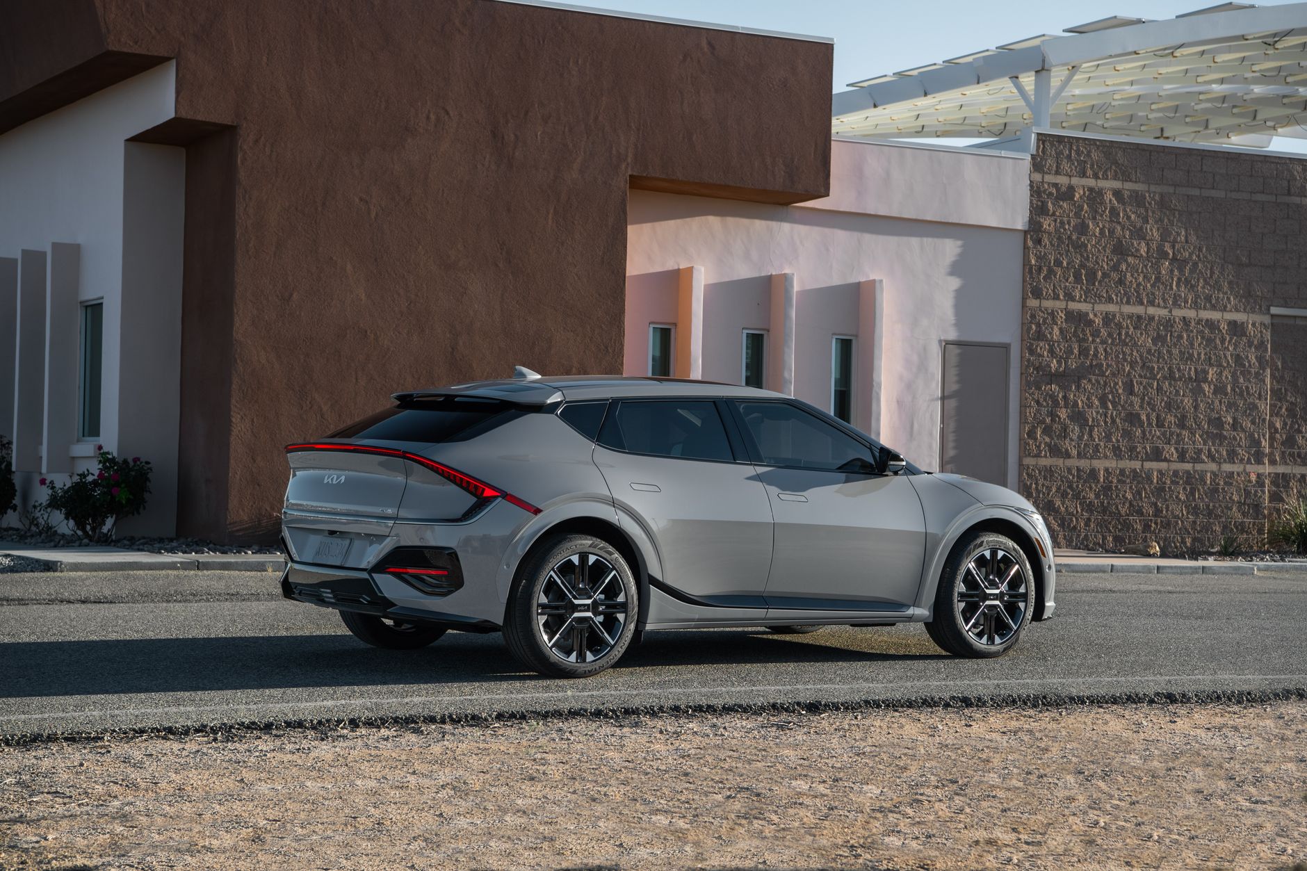Sleek Kia EV6 GT-Line parked outside a modern building, showcasing futuristic design and innovation.