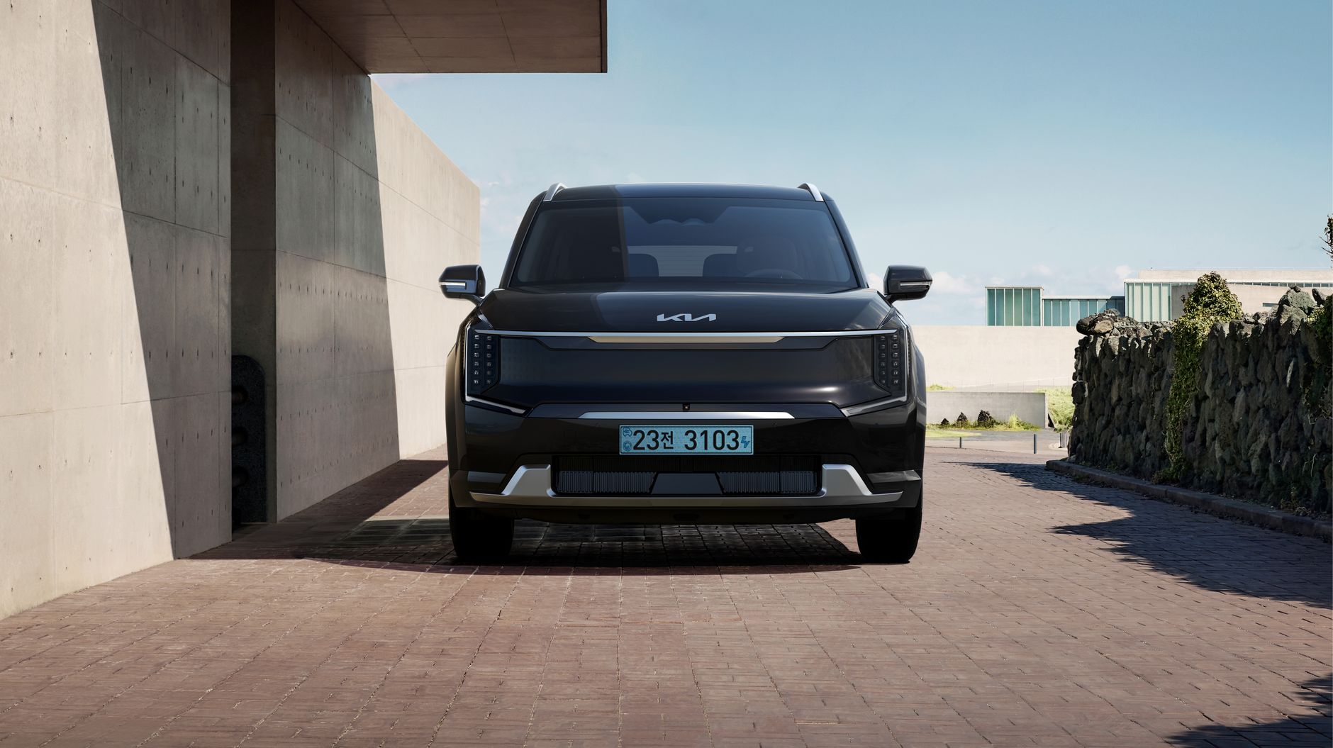 Sleek black electric SUV parked in a contemporary architectural environment.