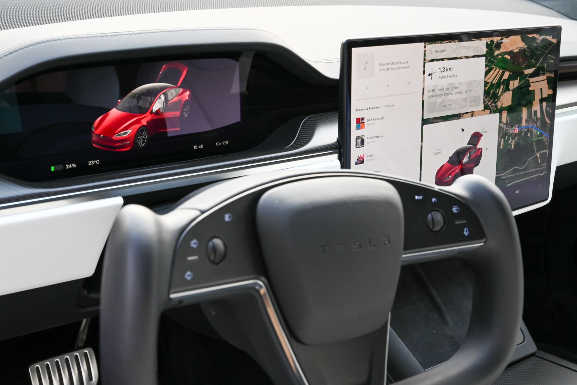 Explore the sleek interior of a modern electric car featuring advanced touchscreens and innovative steering design.