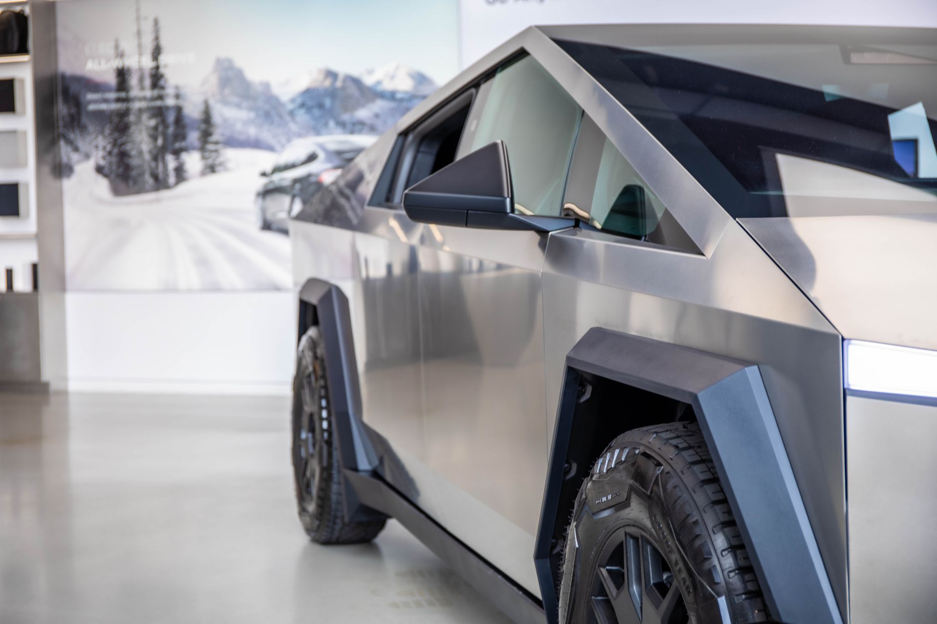 Close-up of a futuristic electric truck showcased indoors, emphasizing modern lines and design.