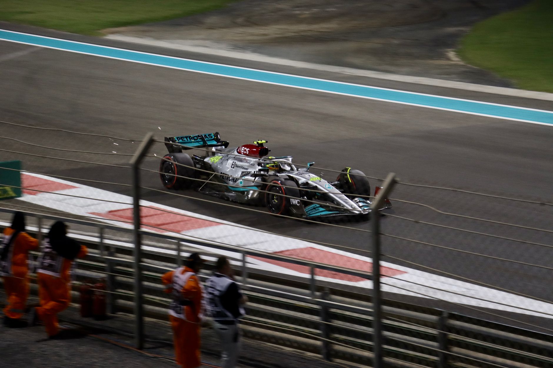 Mercedes Formula 1 car races at Abu Dhabi's Yas Marina Circuit, showcasing speed and precision.
