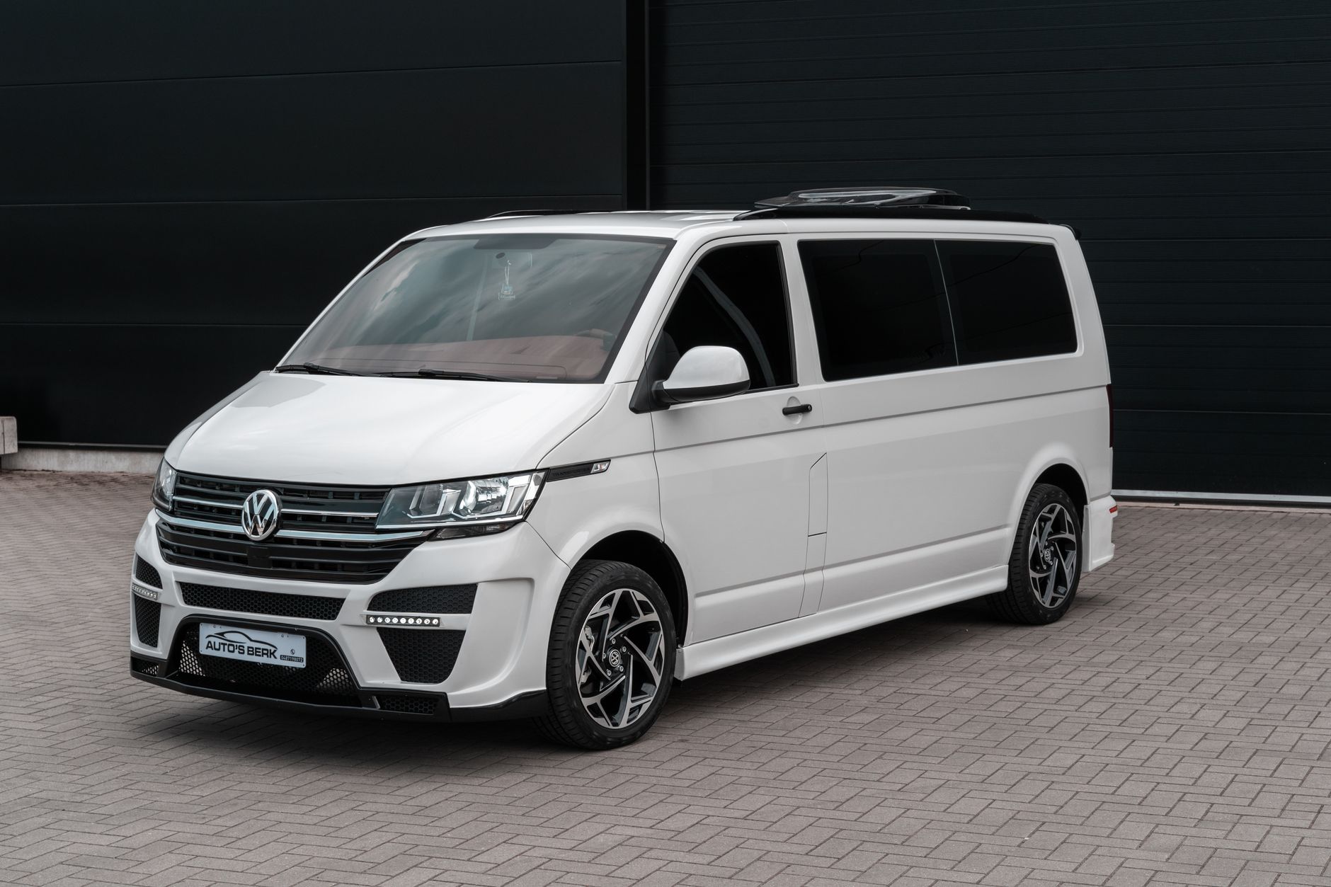 A modern Volkswagen van parked outdoors, showcasing urban style and design.