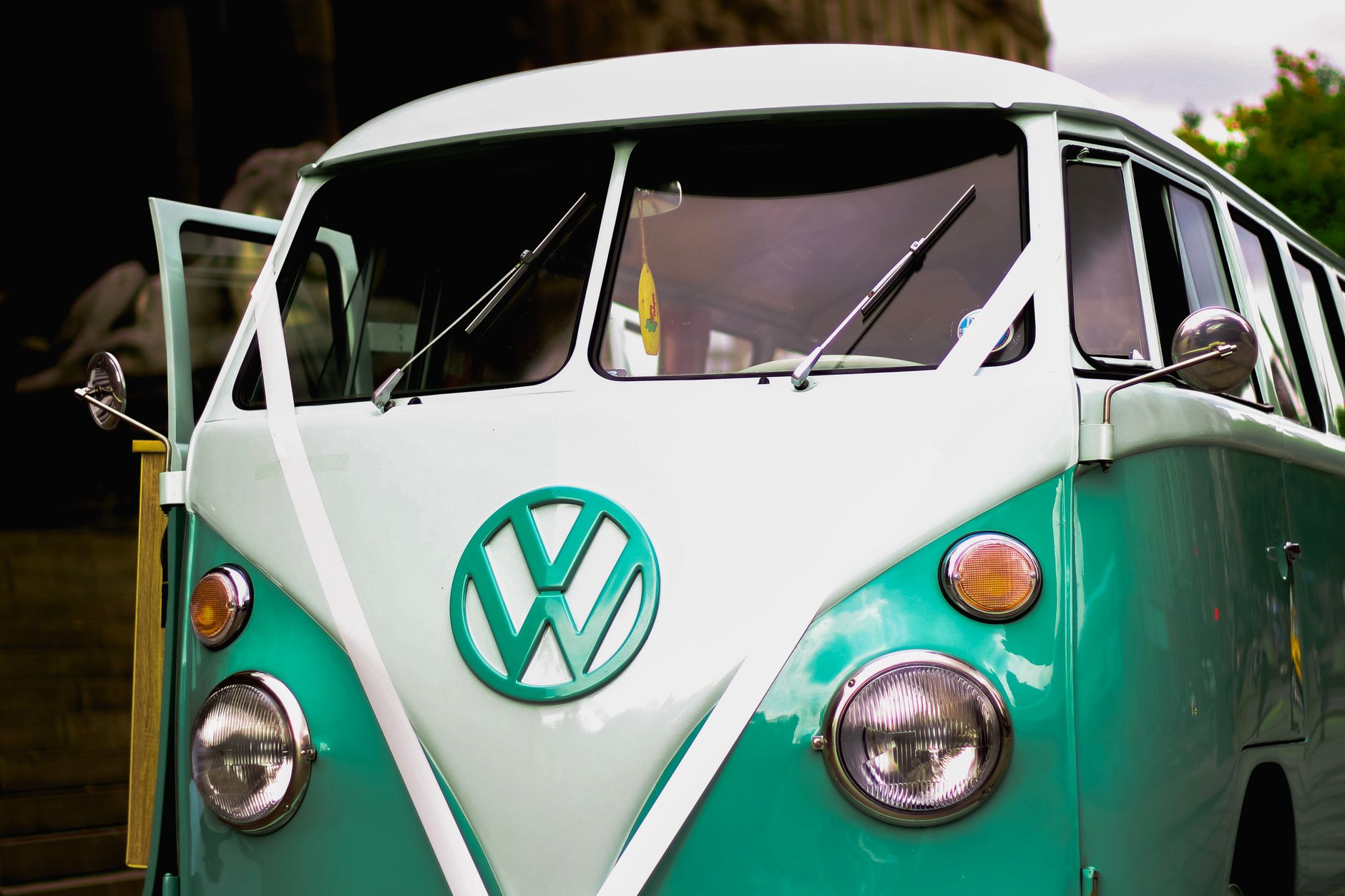 Close-up of a classic Volkswagen combi van with a vintage design in an outdoor scene.