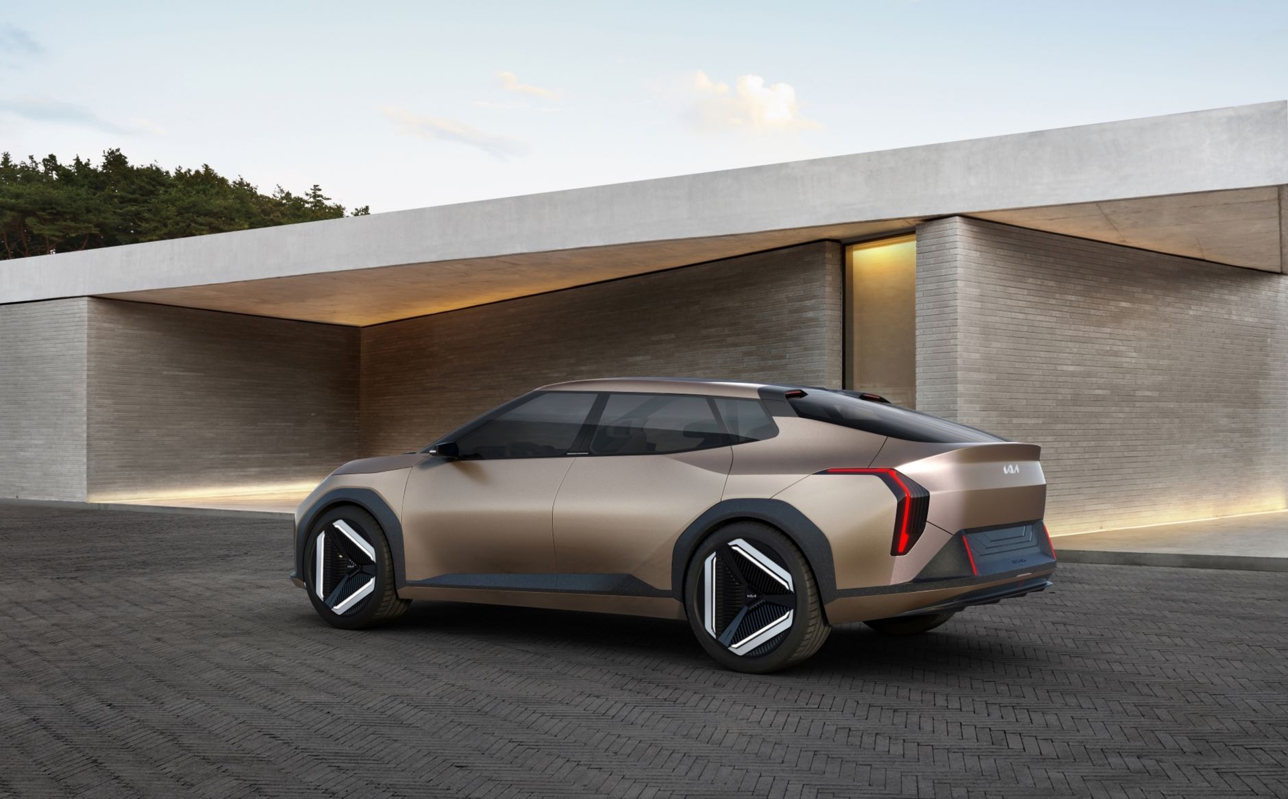 Sleek Kia concept electric vehicle parked in a modern architectural setting, showcasing design innovation.