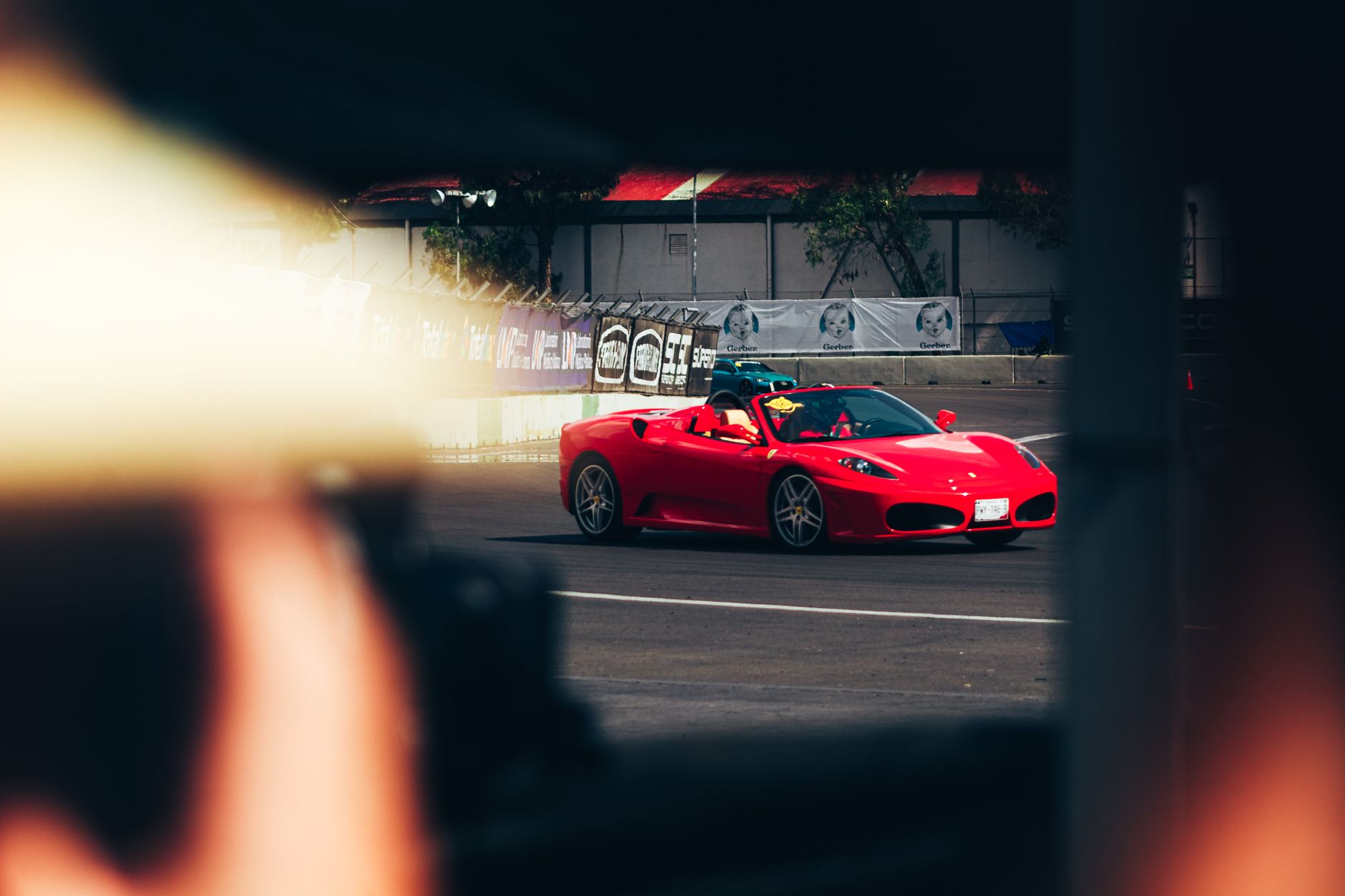Red sports car captured on a race track, showcasing speed and modern design.