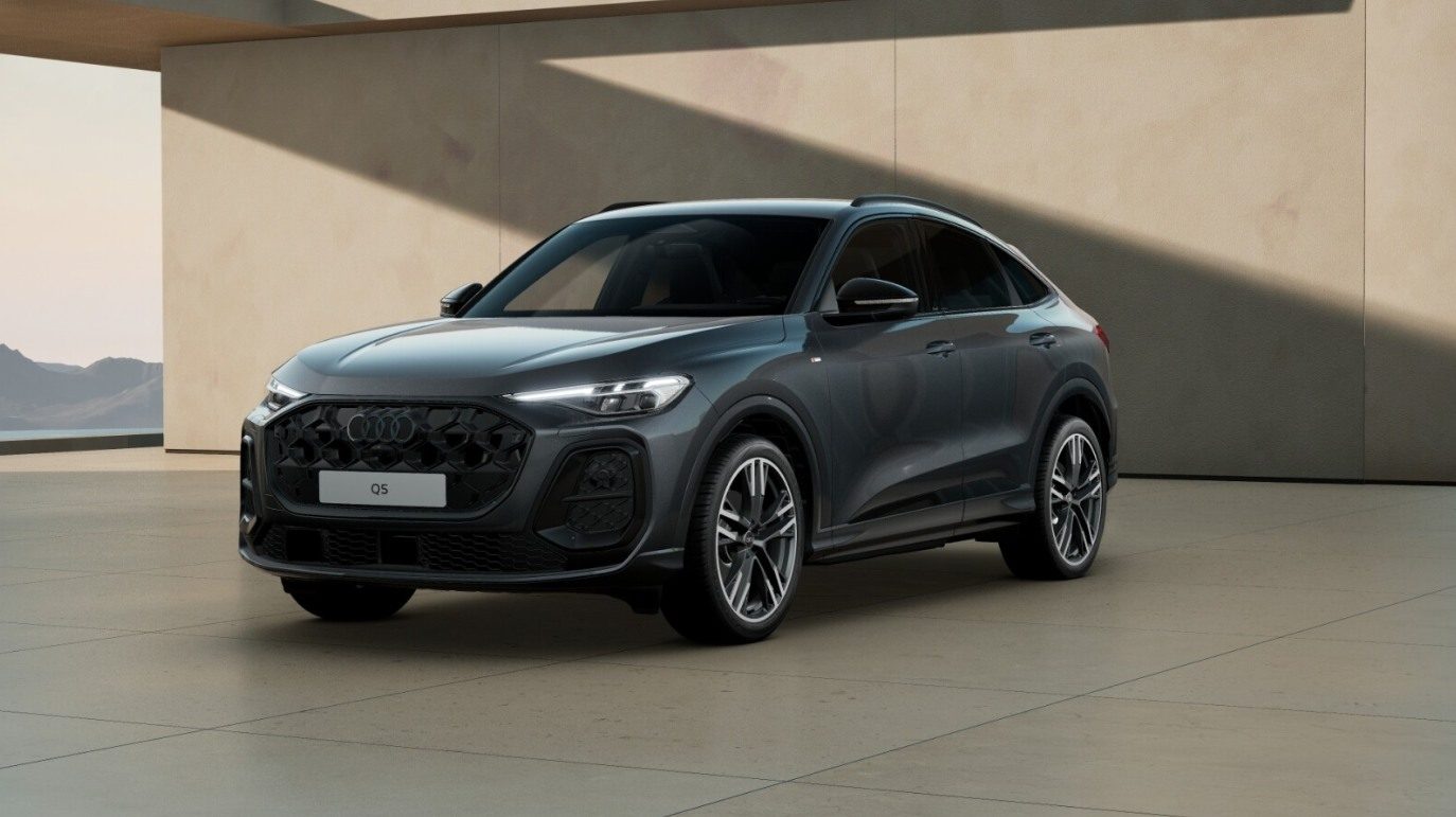 Szare Audi Q5 zaparkowane przed nowoczesnym budynkiem w eleganckiej, minimalistycznej scenerii.