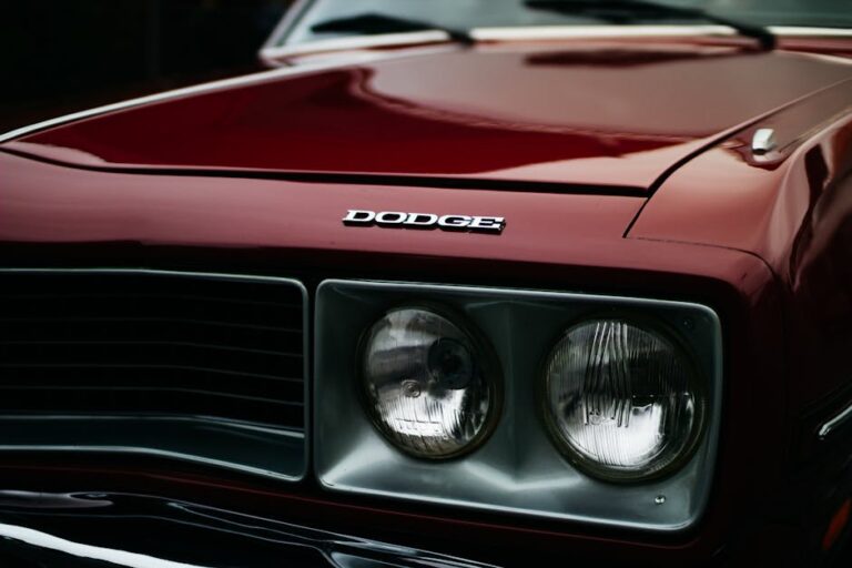 Close-up of a Dodge Challenger RT's front grille and headlamps, showcasing the classic muscle car's iconic design.
